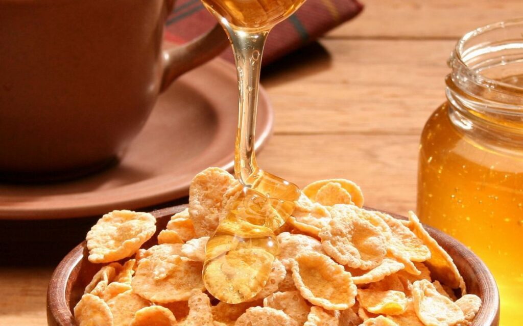 pouring honey over cereal 
